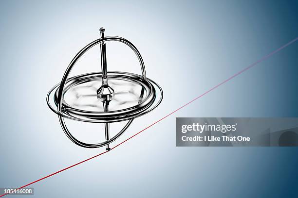 spinning gyroscope, balancing on a red cable - pinpoint accuracy stock pictures, royalty-free photos & images