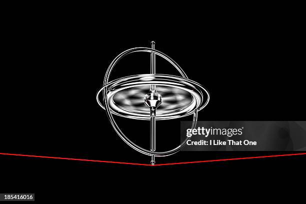 spinning gyroscope, balancing on a red cable - twirling stock pictures, royalty-free photos & images