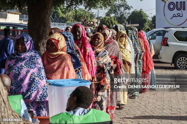 Women queue to cast their votes during the constitutional referendum at a polling station in N'Djamena, on December 17, 2023. Polls opened in a...