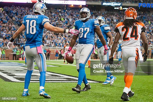 Wide receiver Kris Durham celebrates with tight end Brandon Pettigrew of the Detroit Lions after Pettigrew scored a touchdown during the first half...