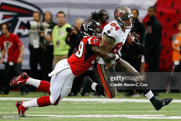 Tom Crabtree of the Tampa Bay Buccaneers pulls in this reception against Joplo Bartu of the Atlanta Falcons at Georgia Dome on October 20, 2013 in...