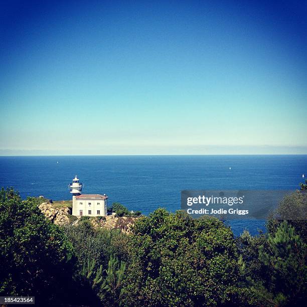 looking down on a solitary lighthouse towards sea - guipuzcoa province stock pictures, royalty-free photos & images