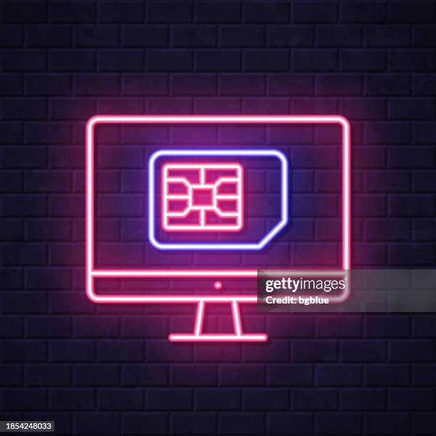 desktop computer with sim card. glowing neon icon on brick wall background - computer screen close up stock illustrations