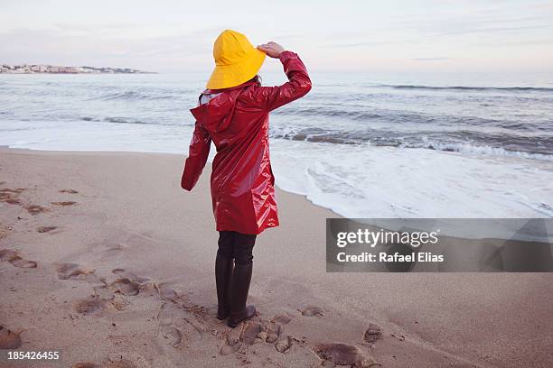 woman in rainhat and raincoat - rain hat stock pictures, royalty-free photos & images