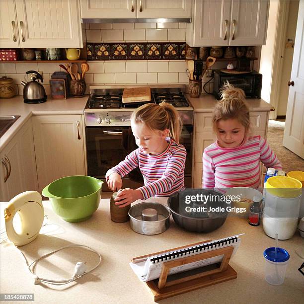Two Children Cooking Together In The Kitchen, Foto de stock