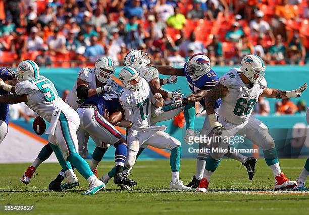 Ryan Tannehill of the Miami Dolphins has the ball knocked out by Stephon Gilmore of the Buffalo Bills during a game at Sun Life Stadium on October...