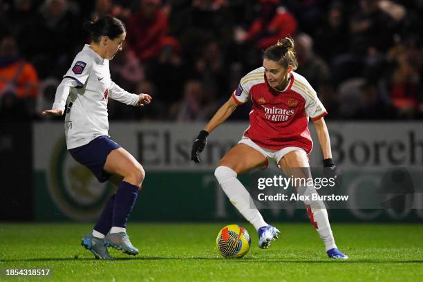 Vivianne Miedema of Arsenal runs with the ball under pressure from Angharad James of Tottenham Hotspur during the FA Women's Continental Tyres League...