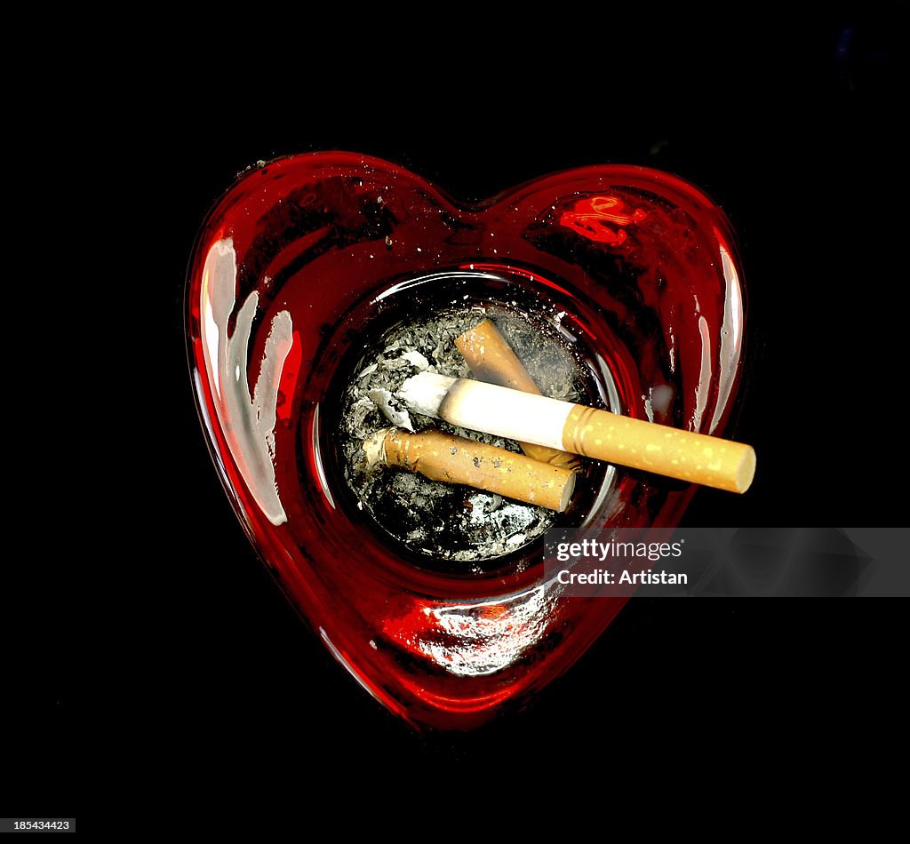 Cigarettes in a heart shaped ashtray