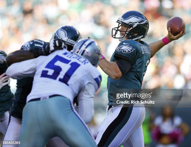 Quarterback Matt Barkley of the Philadelphia Eagles gets help from offensive tackle Jason Peters on a block of defensive end Kyle Wilber the Dallas...
