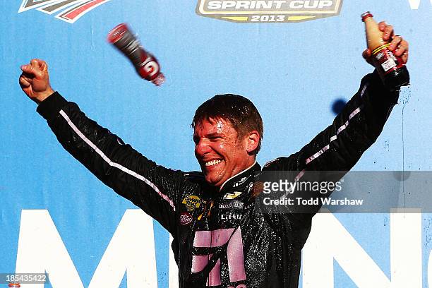 Jamie McMurray, driver of the Cessna Chevrolet, celebrates in Victory Lane after winning the NASCAR Sprint Cup Series Camping World RV Sales 500 at...
