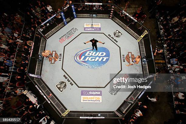 Referee Herb Dean introduce UFC heavyweight champion Cain Velasquez and Junior Dos Santos before their UFC heavyweight championship bout at the...