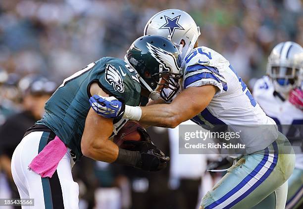 Tight end Brent Celek of the Philadelphia Eagles makes a first down catch and is tackled by linebacker Sean Lee of the Dallas Cowboys in the fourth...