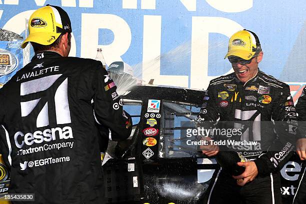 Jamie McMurray, driver of the Cessna Chevrolet, celebrates in Victory Lane with crew members after winning the NASCAR Sprint Cup Series Camping World...
