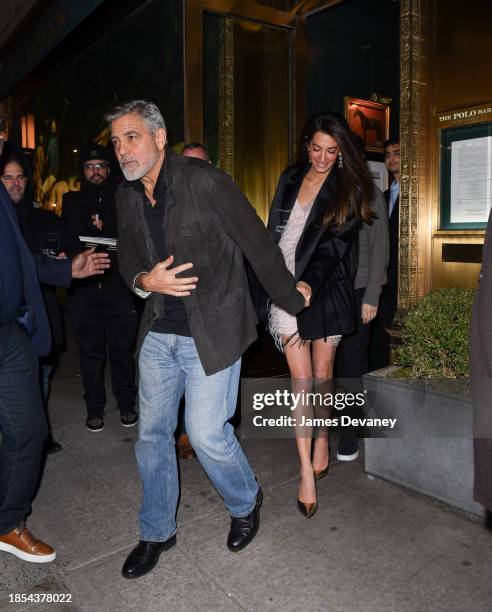 George Clooney and Amal Clooney leave the Polo Bar on December 14, 2023 in New York City.