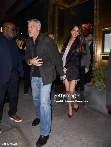 George Clooney and Amal Clooney leave the Polo Bar on December 14, 2023 in New York City.