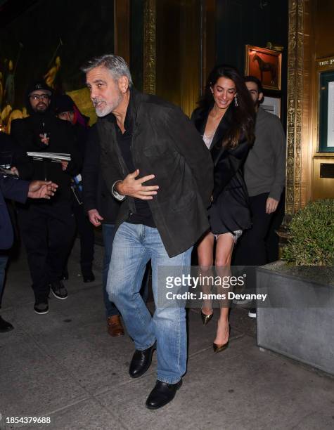 George Clooney and Amal Clooney leave the Polo Bar on December 14, 2023 in New York City.