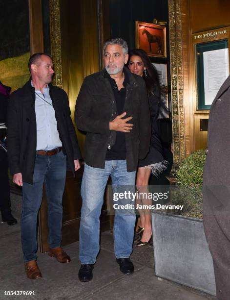 George Clooney and Amal Clooney leave the Polo Bar on December 14, 2023 in New York City.