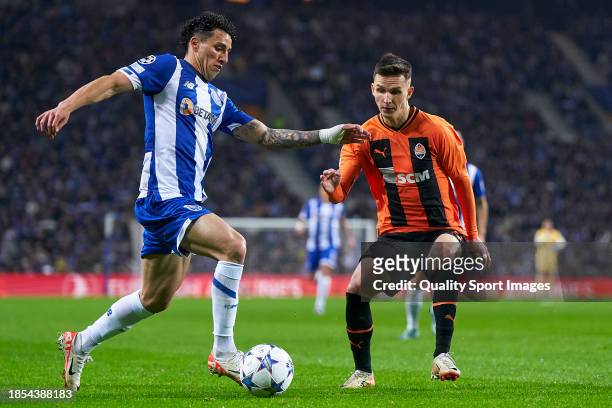 Dmytro Kryskiv of Shakhtar Donetsk competes for the ball with Jorge Sanchez of FC Porto during the UEFA Champions League match between FC Porto and...