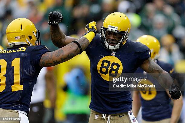 Jermichael Finley of the Green Bay Packers celebrates with Andrew Quarless scoring a touchdown in the first quarter against the Cleveland Browns...