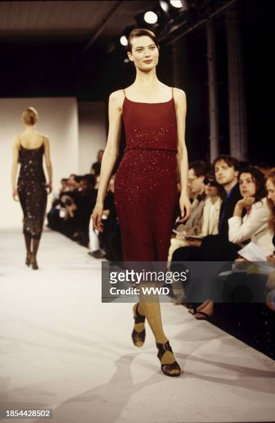 Model Shalom Harlow wearing a sequined red dress with spaghetti straps in the Marc Jacobs Fall/Winter 1996 show in New York