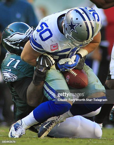 Dallas Cowboys middle linebacker Sean Lee almost loses the ball while being tackled after a fourth-quarter interception against the Philadelphia...