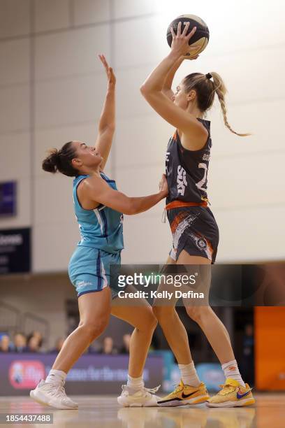 Cassandra Brown of the Fire passes against Maddison Rocci of the Flyers during the WNBL match between Southside Flyers and Townsville Fire at State...
