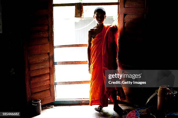 Year old Mong Sanu, who is training to become a monk, is seen inside his monastary before the Probarona Purnima festival on October 19, 2013 in Ramu,...