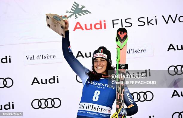 First-placed Italy's Federica Brignone celebrates on the podium of the Women's SuperG race at the FIS Alpine Skiing World Cup event in Val-d'Isere,...