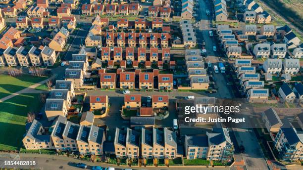 drone/aerial view of a new housing development in the uk. most of the roofs have solar panels - sustainable living - abstract art stock pictures, royalty-free photos & images