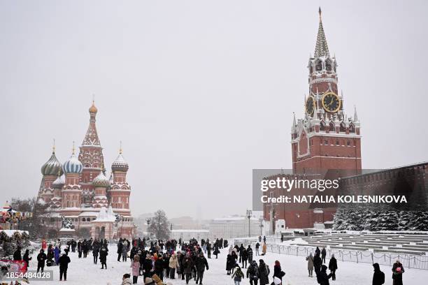Local residents stroll through Moscow's snow-covered Red Square on December 17, 2023. The height of snowdrifts in Moscow on December 17, 2023 reached...