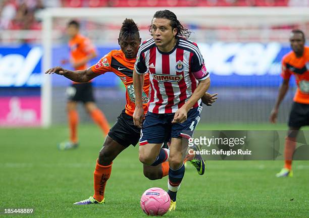 Héctor Reynoso of Chivas, fights for the ball with Duvier Riascos of Pachuca during the match between Chivas and Pachuca as part of the Apertura 2013...