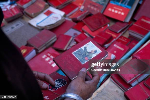 Copies of the red book of chairman Mao Tse-Tung for sale in the local market in the ancient city of Dali in Yunnan, Southwest China. Dali is a...