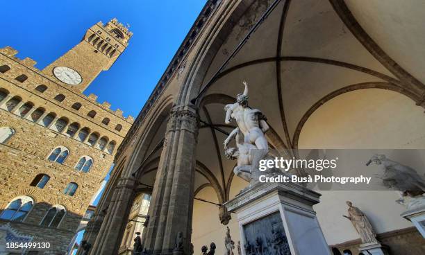 statue of the rape of the sabine women in loggia dei lanzi or loggia della signoria, in piazza della signoria in florence, italy - loggia dei lanzi stock pictures, royalty-free photos & images