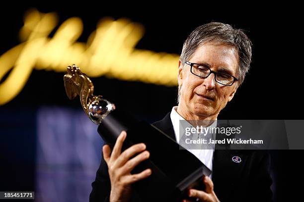 Boston Red Sox owner John Henry celebrates with the trophy after they defeated the Detroit Tigers in Game Six of the American League Championship...