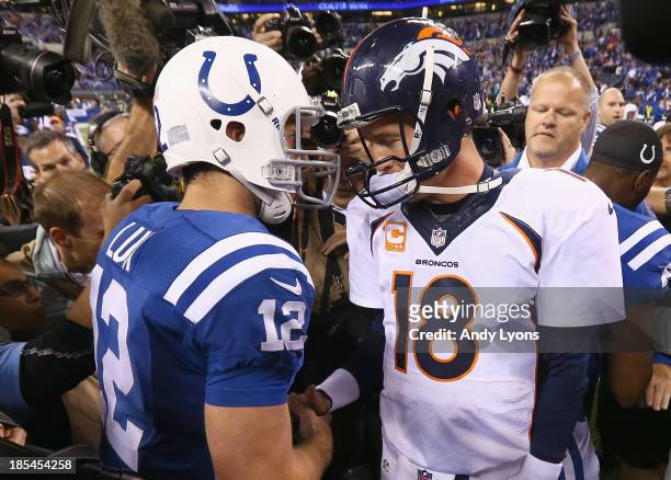 Andrew Luck of the Indianapolis Colts and Peyton Manning of the Denver Broncos meet after the game at Lucas Oil Stadium on October 20, 2013 in...