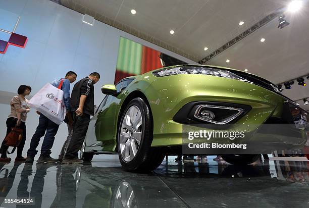 Visitors look at a Honda Jade vehicle displayed at the Dongfeng Honda Automobile Co. Booth, the joint venture between Dongfeng Motor Corp. And Honda...