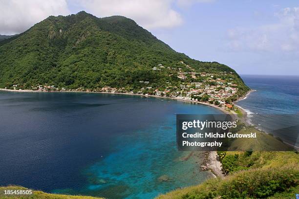 mountain over blue water - dominica stock pictures, royalty-free photos & images