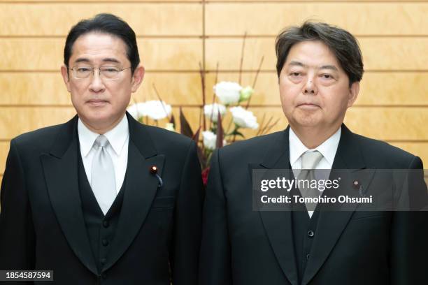 Japan's Prime Minister Fumio Kishida poses with newly appointed Chief Cabinet Secretary Yoshimasa Hayashi during a photo session at the prime...