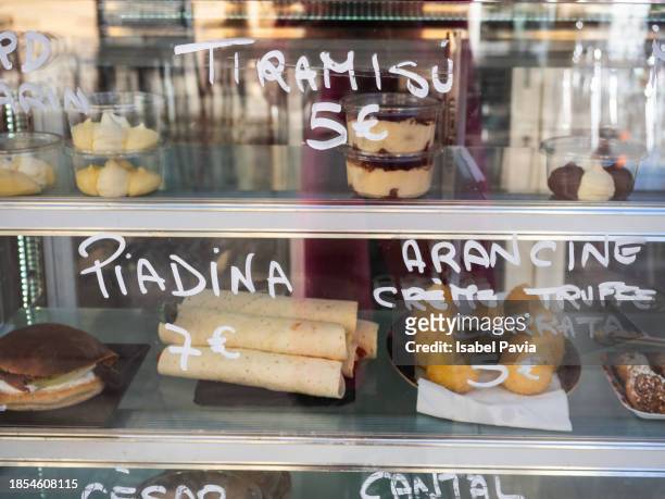 desserts and pastries on tray in bakery, store window - chocolate souffle stock-fotos und bilder