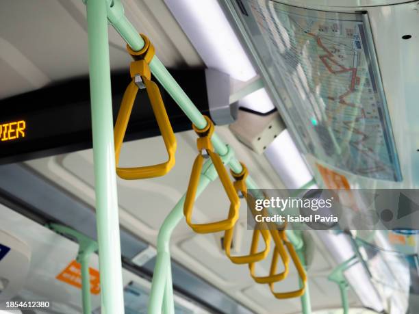 close-up of yellow handrails inside the bus - bus handrail stock pictures, royalty-free photos & images