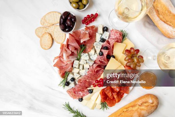 charcuterie board prosciutto ham, salami and cheese parmesan roquefort . festive serving of cold meat appetizers for lunch or dinner for christmas, new year, wedding, anniversary, birthday party - roquefort stock pictures, royalty-free photos & images