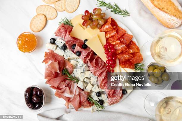 charcuterie board prosciutto ham, salami and cheese parmesan roquefort . festive serving of cold meat appetizers for lunch or dinner for christmas, new year, wedding, anniversary, birthday party - roquefort stock pictures, royalty-free photos & images