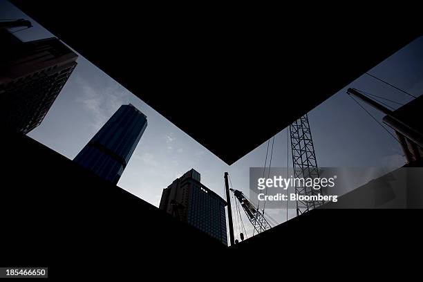Construction cranes stand in the North Point area of Hong Kong, China, on Friday, Oct. 18, 2013. Hong Kong's September consumer prices rose 4.6% from...