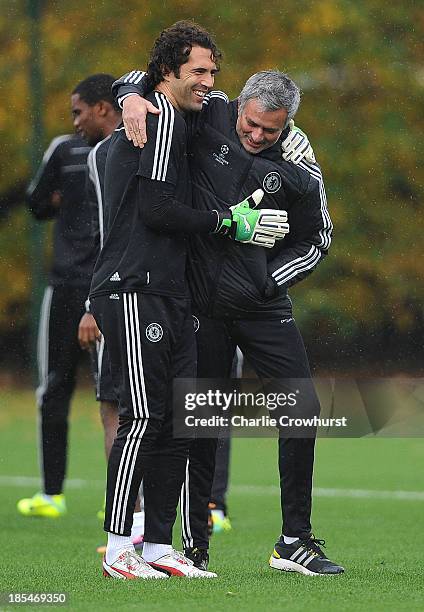 Chelsea manager Jose Mourinho hugs with Henrique Hilario during a Chelsea training session ahead of their UEFA Champions League Group E match against...