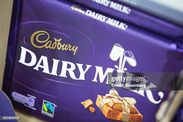 Multi-pack bars of Cadbury "Dairy Milk" chocolate, manufactured by Kraft Foods Inc., sit displayed for sale inside an Asda supermarket, the U.K....