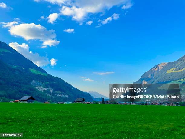 beautiful village in mountain valley with blue sky and clouds in a sunny summer day in lungern, obwalden, switzerland - lungern stock pictures, royalty-free photos & images