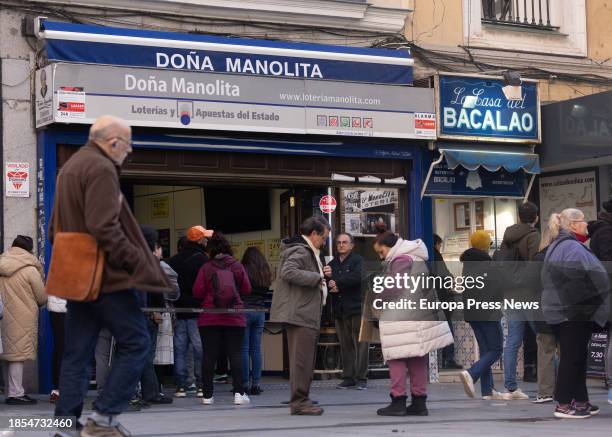 Several people queue up to buy tickets for the Extraordinary Christmas Lottery Draw at the Doña Manolita Lottery Administration on December 14 in...