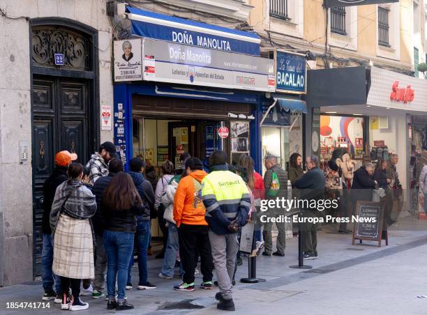 Several people queue up to buy tickets for the Extraordinary Christmas Lottery Draw at the Doña Manolita Lottery Administration on December 14 in...