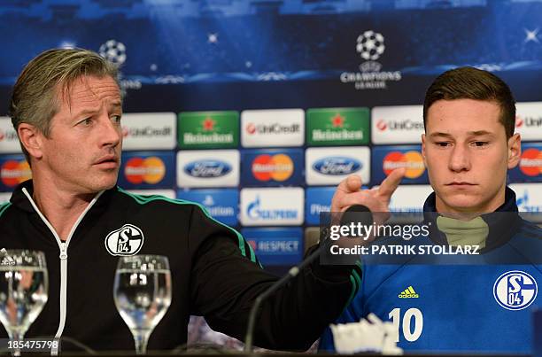 Schalke's head coach Jens Keller and Schalke's midfielder Julian Draxler answer questions during a press conference at the press room, in...