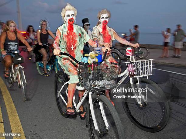 Participants take part in the zombie bike ride on the A1A next to the Atlantic Ocean on October 20, 2013 in Key West, Florida. Thousands of costumed...